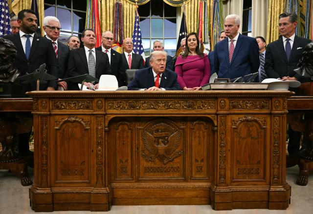 US President Donald Trump speaks during a bill signing ceremony with members of the 1980 US Olympic men's ice hockey team in the Oval Office of the White House in Washington, DC, on December 12, 2025. The legislation will award all of the players with Congressional Gold Medals to recognize the 45th anniversary of the US victory at the 1980 Winter Olympic Games. (Photo by Jim WATSON / AFP)