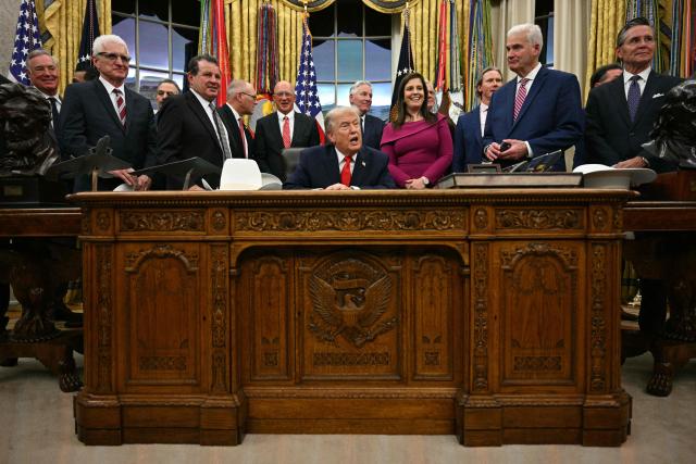 US President Donald Trump speaks during a bill signing ceremony with members of the 1980 US Olympic men's ice hockey team in the Oval Office of the White House in Washington, DC, on December 12, 2025. The legislation will award all of the players with Congressional Gold Medals to recognize the 45th anniversary of the US victory at the 1980 Winter Olympic Games. (Photo by Jim WATSON / AFP)