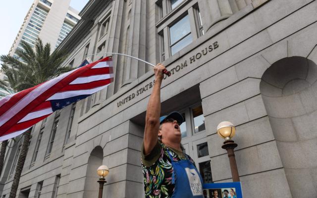 Residents of New Orleans protest outside of the US Customs and Border Protection Office on December 12, 2025 in New Orleans, Louisiana. The Department of Homeland Security launched Operation Catahoula Crunch on December 3 with the stated goal of arresting illegal immigrants with criminal records in New Orleans and surrounding parishes. (Photo by Matthew HATCHER / AFP)
