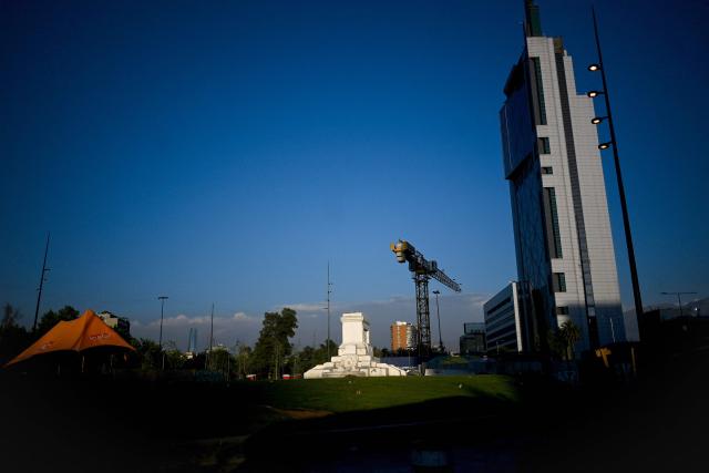 A view of the pedestal where the Baquedano monument once stood in Plaza Italia, the symbolic epicenter of the 2019 social unrest, taken in Santiago on December 12, 2025. The statue of General Manuel Baquedano, a historic figure in Chile's War of the Pacific, was removed in 2021 after repeated acts of vandalism during mass protests demanding social and political reforms. (Photo by Eitan ABRAMOVICH / AFP)
