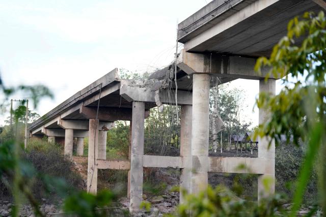 A damaged bridge is seen in Pursat in Pursat province on December 13, 2025, amid clashes along the Cambodia-Thailand border. The latest clashes between the Southeast Asian neighbours, which stem from a long-running dispute over the colonial-era demarcation of their 800-kilometre (500-mile) frontier, have displaced around half a million on both sides. (Photo by AFP)