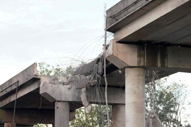 A damaged bridge is seen in Pursat in Pursat province on December 13, 2025, amid clashes along the Cambodia-Thailand border. The latest clashes between the Southeast Asian neighbours, which stem from a long-running dispute over the colonial-era demarcation of their 800-kilometre (500-mile) frontier, have displaced around half a million on both sides. (Photo by AFP)