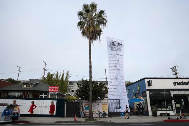 A 40-foot-long banner, depicting a purchase receipt, is displayed by the progressive organization MoveOn to protest against US President Donald Trump's tariffs on imports, in Los Angeles, California, on December 12, 2025. (Photo by Patrick T. Fallon / AFP)