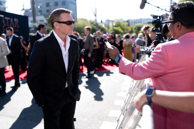 Avatar actor Sam Worthington speaks to the media on the red carpet during the Australasian premiere of Avatar Fire and Ash in Wellington on December 13, 2025. (Photo by Marty MELVILLE / AFP)