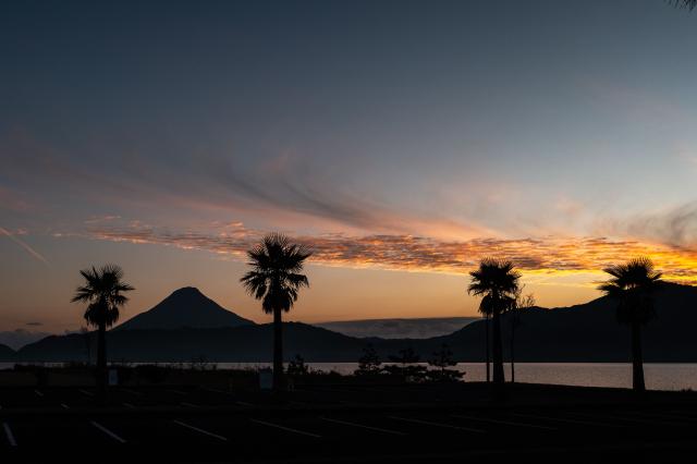A general view shows Mount Kaimon (L) after sunset from lake Ikeda in Ibusuki, Kagoshima Prefecture on December 10, 2025. (Photo by Philip FONG / AFP)