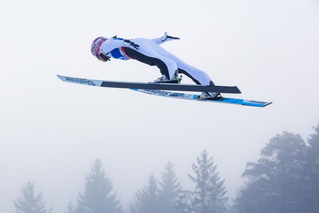 Canada's Abigail Strate soars through the air during the qualification to the Women's Individual Large Hill HS140 event of the FIS Ski Jumping World Cup in Klingenthal, eastern Germany on December 13, 2025 (Photo by JENS SCHLUETER / AFP)