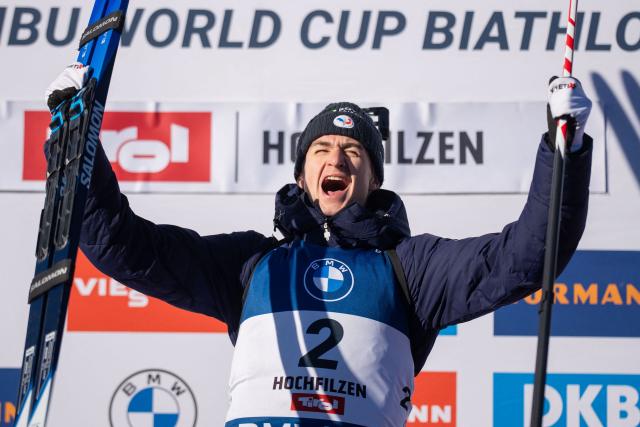 Winner first placed France's Eric Perrot celebrates on the podium afer the men's 12,5km pursuit event of the IBU Biathlon World Cup in Hochfilzen, Austria on December 13, 2025. (Photo by GEORG HOCHMUTH / APA / AFP) / Austria OUT