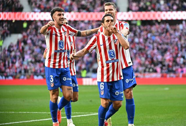 Atletico Madrid's Spanish midfielder #06 Koke celebrates scoring his team's first goal during the Spanish league football match between Club Atletico de Madrid and Valencia CF at Metropolitano Stadium in Madrid on December 13, 2025. (Photo by Javier SORIANO / AFP)