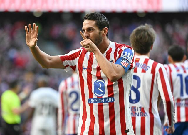 Atletico Madrid's Spanish midfielder #06 Koke celebrates scoring his team's first goal during the Spanish league football match between Club Atletico de Madrid and Valencia CF at Metropolitano Stadium in Madrid on December 13, 2025. (Photo by Javier SORIANO / AFP)