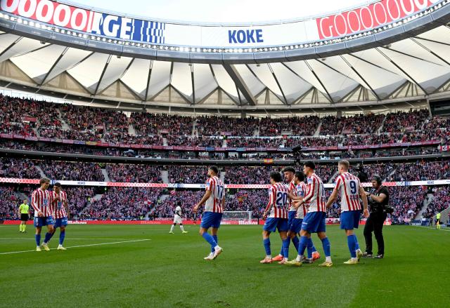 Atletico Madrid's Spanish midfielder #06 Koke celebrates with teammates scoring his team's first goal during the Spanish league football match between Club Atletico de Madrid and Valencia CF at Metropolitano Stadium in Madrid on December 13, 2025. (Photo by Javier SORIANO / AFP)