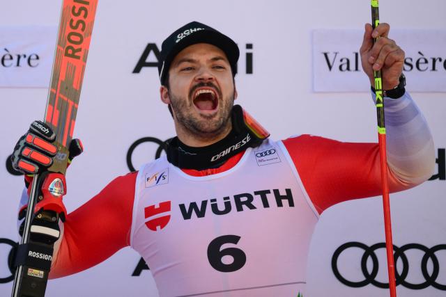 Switzerland's Loic Meillard celebrates his victory on the podium after the Men's Giant Slalom event of the FIS Alpine Skiing World Cup in Val d'Isere, on December 13 2025. (Photo by Olivier CHASSIGNOLE / AFP)
