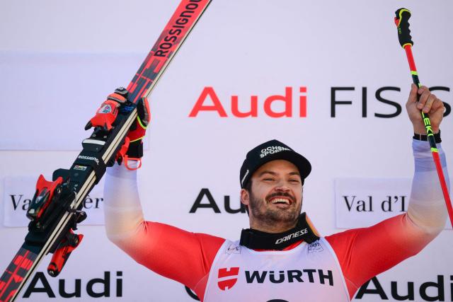 Switzerland's Loic Meillard celebrates his victory on the podium after the Men's Giant Slalom event of the FIS Alpine Skiing World Cup in Val d'Isere, on December 13 2025. (Photo by Olivier CHASSIGNOLE / AFP)