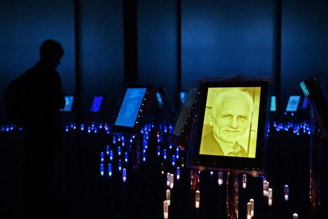 (FILES) A picture of 2022 Nobel Peace Prize laureate, jailed Belarusian activist Ales Bialiatski is seen among portraits of previous winners in the "peace garden" at the Nobel Peace Center in Oslo, on December 8, 2022. Belarus has freed 123 prisoners, including protest leader Maria Kalesnikava and Nobel Peace Prize laureate Ales Bialiatski, rights groups and state media reported on December 13, 2025, after the US envoy earlier said Washington was lifting sanctions on Belarusian potassium. (Photo by Sergei GAPON / AFP)
