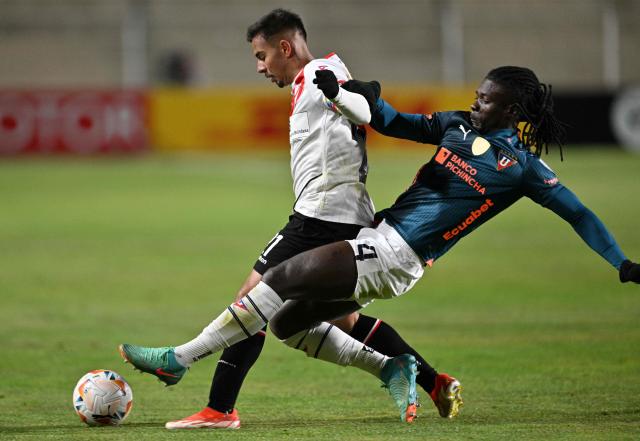 (FILES) Liga de Quito's Haitian defender Ricardo Ade (R) and Always Ready's midfielder Robson Matheus fight for the ball during the Copa Sudamericana knockout round playoff second leg football match between Bolivia's Always Ready and Ecuador's Liga de Quito at the Municipal de Villa Ingenio stadium in el Alto, Bolivia, on July 25, 2024. “Free the country, we want to live in peace,” said Ricardo Ade, a member of the Haitian national team that will compete in the World Cup in the United States, who made this appeal to the violent gangs that have caused a crisis in his impoverished nation. (Photo by AIZAR RALDES / AFP)