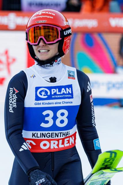 Germany's Katharina Schmid reacts after competing in the Women's Individual Large Hill HS140 event of the FIS Ski Jumping World Cup in Klingenthal, eastern Germany on December 13, 2025. (Photo by JENS SCHLUETER / AFP)