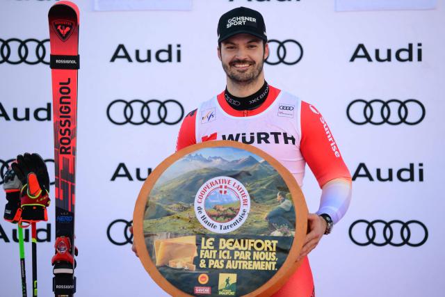 Switzerland's Loic Meillard celebrates his victory on the podium after the Men's Giant Slalom event of the FIS Alpine Skiing World Cup in Val d'Isere, on December 13 2025. (Photo by Olivier CHASSIGNOLE / AFP)