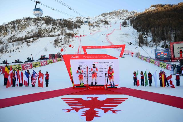 (From L) second-placed Switzerland's Luca Aerni, first-placed Switzerland's Loic Meillard and third-placed Switzerland's Marco Odermatt celebrate after the Men's Giant Slalom event of the FIS Alpine Skiing World Cup in Val d'Isere, on December 13 2025. (Photo by Olivier CHASSIGNOLE / AFP)