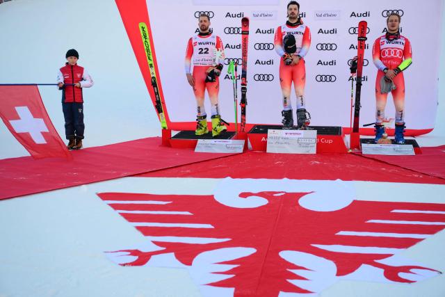 (From L) second-placed Switzerland's Luca Aerni, first-placed Switzerland's Loic Meillard and third-placed Switzerland's Marco Odermatt celebrate after the Men's Giant Slalom event of the FIS Alpine Skiing World Cup in Val d'Isere, on December 13 2025. (Photo by Olivier CHASSIGNOLE / AFP)