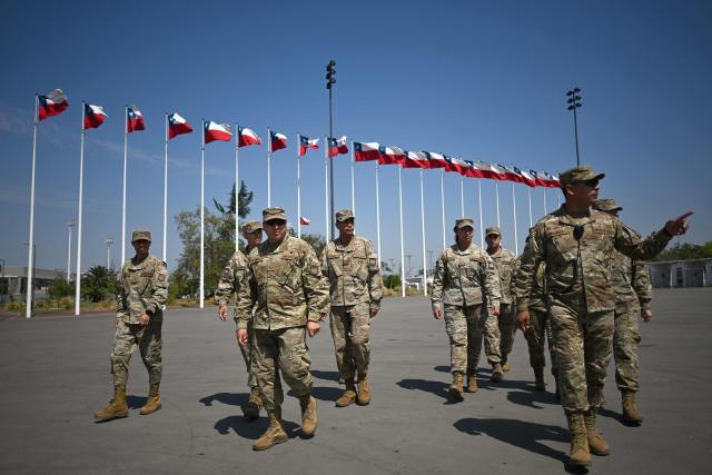 Chile's army officers patrol outside the polling station at the Estadio Nacional ahead of the second round of the presidential election in Santiago on December 13, 2025. Chile votes in a presidential runoff December 14, 2025, between two sharply different candidates: Jeannette Jara, a communist backed by a broad left coalition, and Jose Antonio Kast, a devout far-right politico promising a hard line on security and migration. (Photo by EITAN ABRAMOVICH / AFP)