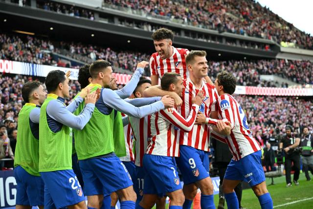 Atletico Madrid's Norwegian forward #09 Alexander Sorloth celebrates with teammates scoring a goal that was later annulled during the Spanish league football match between Club Atletico de Madrid and Valencia CF at Metropolitano Stadium in Madrid on December 13, 2025. (Photo by Javier SORIANO / AFP)