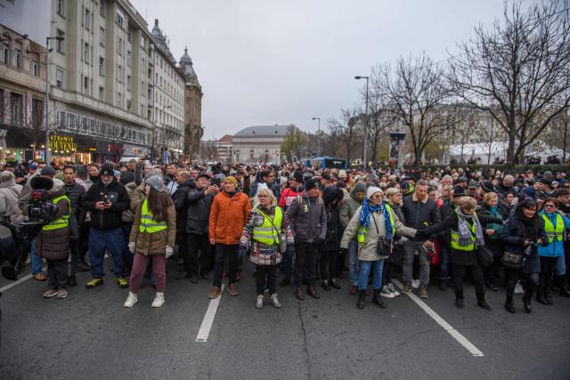 Protesters walk on the street during a demonstration where they demand Hungary's Prime Minister's resignation over the government's perceived inaction about widespread abuse in child care institutions in Budapest, Hungary, on December 13, 2025. The demonstration called by with TISZA party opposition's leader after fresh abuse allegations surfaced at a scandal-hit juvenile detention center. (Photo by Ferenc ISZA / AFP)