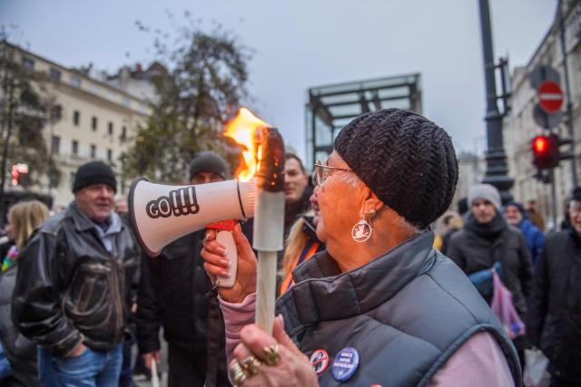 Protesters are seen on the streets during a demonstration where they demand Hungary's Prime Minister's resignation over the government's perceived inaction about widespread abuse in child care institutions in Budapest, Hungary, on December 13, 2025. The demonstration called by with TISZA party opposition's leader after fresh abuse allegations surfaced at a scandal-hit juvenile detention center. (Photo by Ferenc ISZA / AFP)