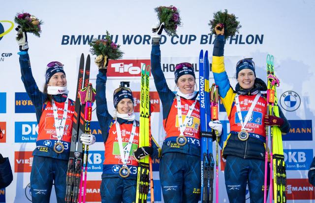 First place winners Sweden's Sweden's Ella Halvarsson, Sweden's Anna Magnusson, Sweden's Elvira Oberg and Sweden's Hanna Oberg celebrate on the podium after winnign the women's 4x6km relay event of the IBU Biathlon World Cup in Hochfilzen, Austria on December 13, 2025. (Photo by GEORG HOCHMUTH / APA / AFP) / Austria OUT