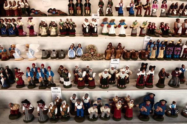 This photograph shows traditional Provencal santon small hand-painted terracotta figurines representing the Christmas nativity scene, traditional in the Provence region, on display at a stand at "La Foire aux Santons" (the Santons' fair) at the Vieux Port in Marseille, southeastern France on December 13, 2025. Santons are small, hand-painted terracotta figurines representing the traditional Provencal Christmas nativity scene. (Photo by Thibaud MORITZ / AFP)