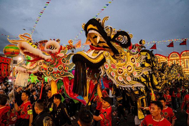People perform dragon and lion dances during the decennial Jiao Festival of Kam Tin in Hong Kong on December 13, 2025. The Taoist ritual, held once every ten years, is performed to give thanks to deities, ward off misfortune and pray for peace and prosperity in the community. (Photo by Leung Man Hei / AFP)