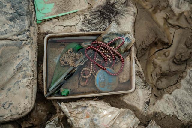 Belongings of a student lie down in mud and water following a flash flood at Darul Mukhlisin Islamic Boarding School in Aceh Tamiang, Northern Sumatra, on December 13, 2025. Devastating floods and landslides have killed 1,006 people in Indonesia, rescuers said December 13 as the Southeast Asian nation grapples with the huge scale of relief efforts. (Photo by Yasuyoshi CHIBA / AFP)