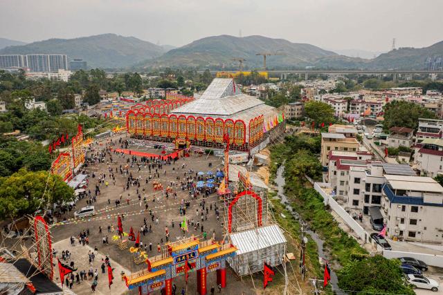 An aerial view shows the large bamboo ceremonial structure for staging rituals and performances during the decennial Jiao Festival of Kam Tin in Hong Kong on December 13, 2025. The Taoist ritual, held once every ten years, is performed to give thanks to deities, ward off misfortune and pray for peace and prosperity in the community. (Photo by Leung Man Hei / AFP)