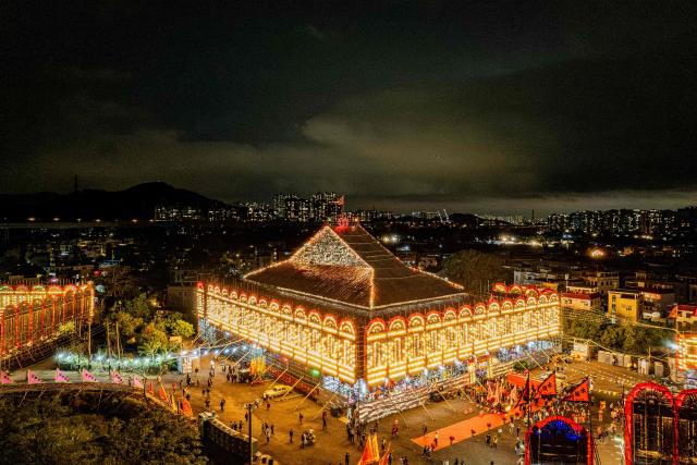 An aerial view shows the large bamboo ceremonial structure for staging rituals and performances during the decennial Jiao Festival of Kam Tin in Hong Kong on December 13, 2025. The Taoist ritual, held once every ten years, is performed to give thanks to deities, ward off misfortune and pray for peace and prosperity in the community. (Photo by Leung Man Hei / AFP)