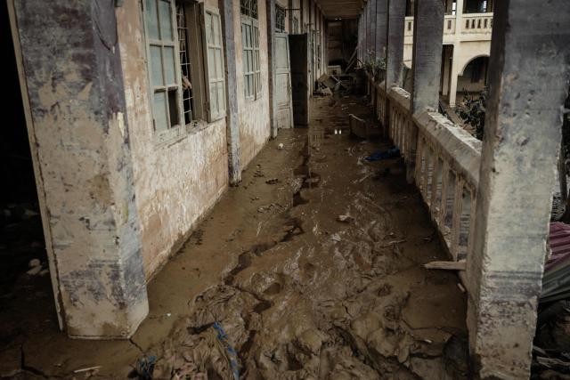 A corridor accumulated with sludge is pictured following a flash flood at Darul Mukhlisin Islamic Boarding School in Aceh Tamiang, Northern Sumatra, on December 13, 2025. Devastating floods and landslides have killed 1,006 people in Indonesia, rescuers said December 13 as the Southeast Asian nation grapples with the huge scale of relief efforts. (Photo by Yasuyoshi CHIBA / AFP)