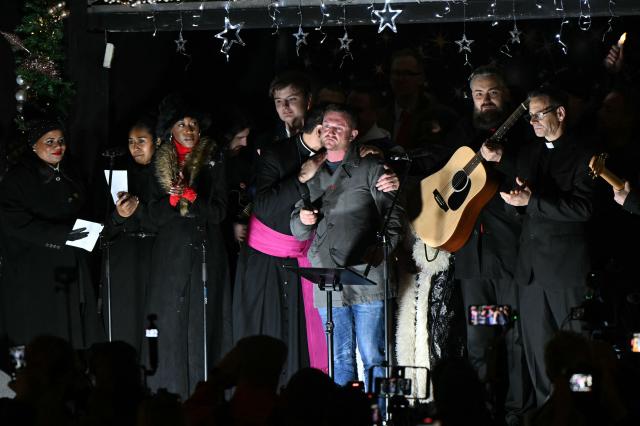 British far-right activist Tommy Robinson, whose real name is Stephen Yaxley-Lennon, addresses supporters on Whitehall in central London on December 13, 2025, at an outdoor carol concert event he organised. (Photo by JUSTIN TALLIS / AFP)