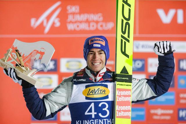 Second placed Austria's Stefan Kraft celebrates on the podium after winning the Men's Individual Large Hill HS140 event of the FIS Ski Jumping World Cup in Klingenthal, eastern Germany on December 13, 2025. Slovenia's Domen Prevc won the event ahead of Austria's Stefan Kraft (2nd) and Germany's Philipp Raimund (3rd). (Photo by JENS SCHLUETER / AFP)