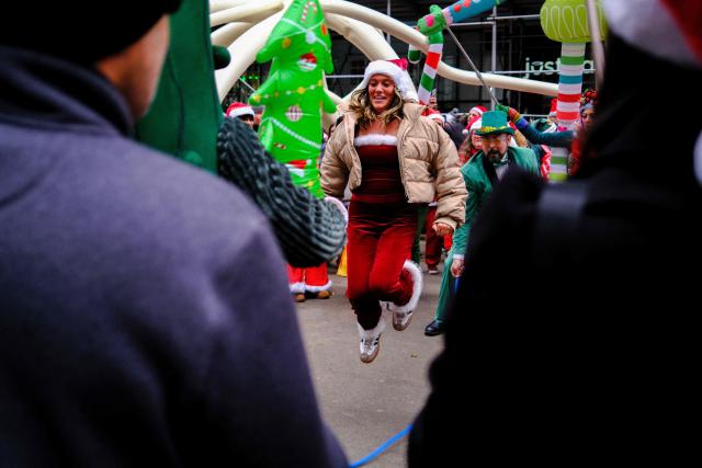 Revellers take part in the 2025 SantaCon NYC pub crawl for charity in New York on December 13, 2025. Proceeds from tickets and donations are given to various charities. (Photo by CHARLY TRIBALLEAU / AFP)