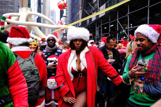 Revellers take part in the 2025 SantaCon NYC pub crawl for charity in New York on December 13, 2025. Proceeds from tickets and donations are given to various charities. (Photo by CHARLY TRIBALLEAU / AFP)