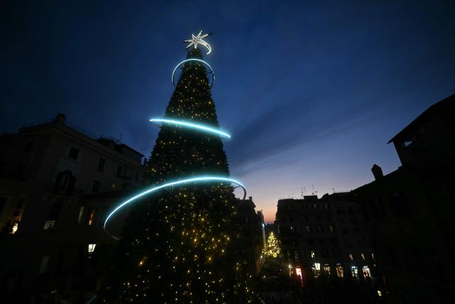 A Christmas tree is seen on the Spanish Steps at night in Rome on December 13, 2025. (Photo by Filippo MONTEFORTE / AFP)