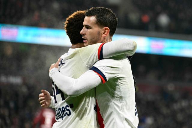 Paris Saint-Germain's French midfielder #14 Desire Doue (L) is congratulated by Paris Saint-Germain's French defender #21 Lucas Hernandez after scoring his team's third goal during the French L1 football match between Metz and Paris Saint-Germain (PSG) at the Stade Saint-Symphorien in Metz, eastern France, on December 13, 2025. (Photo by Jean-Christophe VERHAEGEN / AFP)