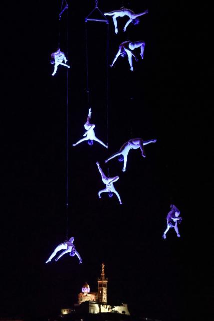 Members of the Zenit dance company perform an aerial ballet titled 'ARIA' above spectators in the old port of Marseille, southern France, during the city’s Christmas celebrations, on December 13, 2025. (Photo by Thibaud MORITZ / AFP)