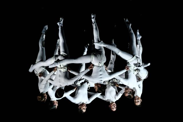 Members of the Zenit dance company perform an aerial ballet titled 'ARIA' above spectators in the old port of Marseille, southern France, during the city’s Christmas celebrations, on December 13, 2025. (Photo by Thibaud MORITZ / AFP)