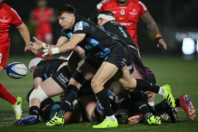 Glasgow Warriors' Scottish scrum-half Jamie Dobie passes the ball during the European Champions Cup rugby union pool 1 match between Glasgow Warriors and Toulouse at Scotstoun Stadium in Glasgow, Scotland on December 13, 2025. (Photo by ANDY BUCHANAN / AFP)
