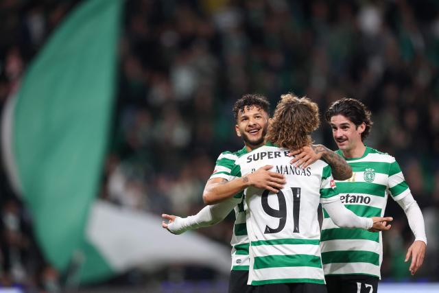 Sporting Lisbon's Colombian forward #97 Luis Suarez (L) celebrates with teammate Portuguese defender #91 Ricardo Mangas after scoring his team's first goal during the Portuguese League football match between Sporting CP and AVS Futebol SAD at Jose Alvalade stadium in Lisbon on December 13, 2025. (Photo by PATRICIA DE MELO MOREIRA / AFP)