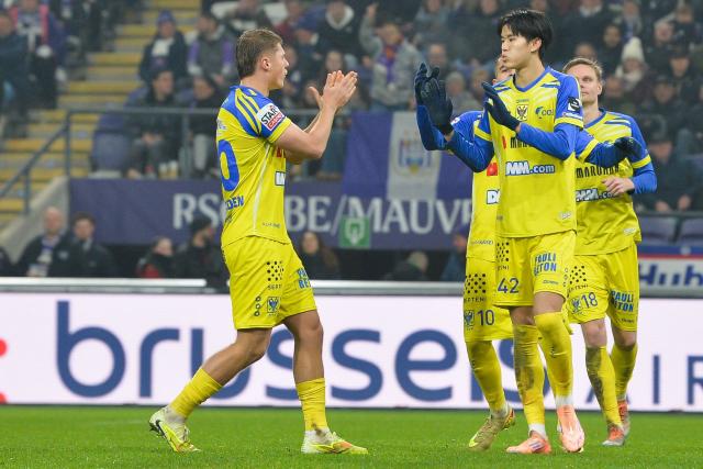 STVV's Japanese forward #42 Keisuke Goto (R) celebrates with teammates after scoring during the Belgian Pro League football match between RSC Anderlecht and Sint-Truidense V.V.  in Brussels on December 13, 2025. (Photo by JILL DELSAUX / Belga / AFP) / Belgium OUT