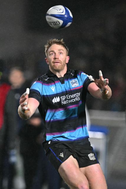Glasgow Warriors' Scottish wing Kyle Steyn gathers the ball during the European Champions Cup rugby union pool 1 match between Glasgow Warriors and Toulouse at Scotstoun Stadium in Glasgow, Scotland on December 13, 2025. (Photo by ANDY BUCHANAN / AFP)