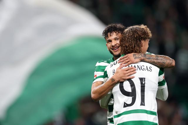Sporting Lisbon's Colombian forward #97 Luis Suarez (L) celebrates with teammate Portuguese defender #91 Ricardo Mangas after scoring his team's first goal during the Portuguese League football match between Sporting CP and AVS Futebol SAD at Jose Alvalade stadium in Lisbon on December 13, 2025. (Photo by PATRICIA DE MELO MOREIRA / AFP)
