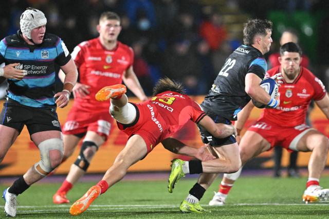 Glasgow Warriors' Scottish scrum-half George Horne is tackled by Toulouse's French centre Paul Costes during the European Champions Cup rugby union pool 1 match between Glasgow Warriors and Toulouse at Scotstoun Stadium in Glasgow, Scotland on December 13, 2025. (Photo by ANDY BUCHANAN / AFP)