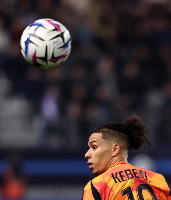 Paris FC's  French midfielder #10 Ilan Kebbal eyes the ball during the French L1 football match between Paris FC and Toulouse FC at the Stade Jean-Bouin in Paris on December 13, 2025. (Photo by FRANCK FIFE / AFP)