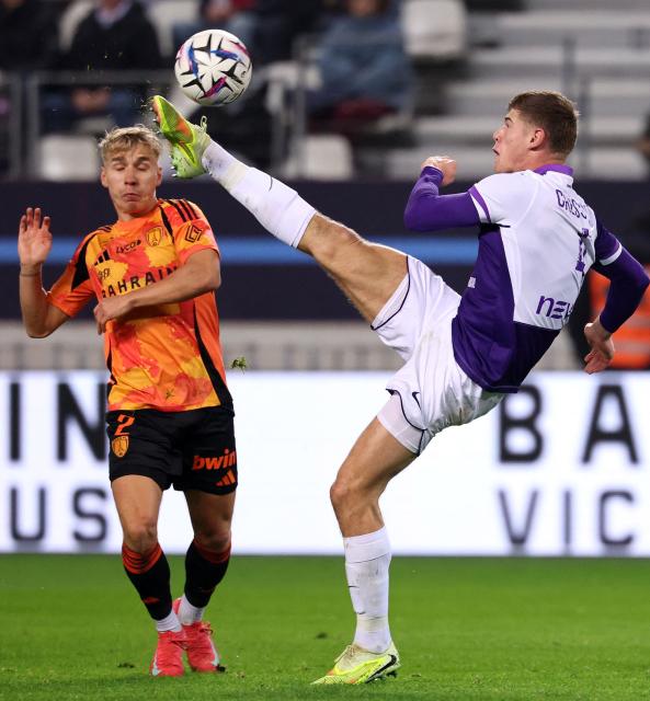Toulouse's English defender #04 Charlie Cresswell (R) kicks the ball next to Paris FC's Finnish defender #02 Tuomas Ollila during the French L1 football match between Paris FC and Toulouse FC at the Stade Jean-Bouin in Paris on December 13, 2025. (Photo by FRANCK FIFE / AFP)