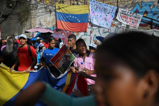Supporters of Venezuelan President Nicolas Maduro take part in a rally against US military activity in the Caribbean, at the San Jose community in the Petare neighborhood in Caracas on December 13, 2025. Venezuelan President Nicolas Maduro on Thursday slammed the US seizure of an oil tanker from his country, calling it an act of "naval piracy" that escalated tensions between Washington and Caracas. (Photo by Federico PARRA / AFP)